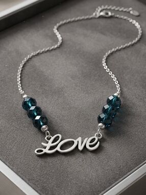 Silver LOVE necklace with Shimmery blue crystal beads NWT